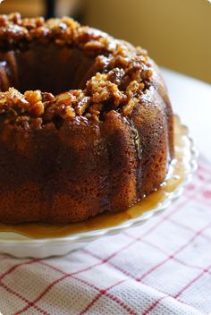 a bundt cake sitting on top of a white plate next to a red and white checkered table cloth