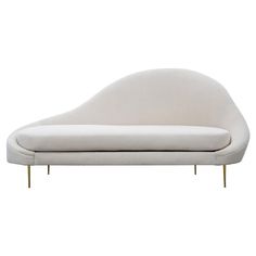 a white chaise lounge chair with gold legs