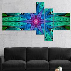 a blue and green abstract art piece hanging on a wall