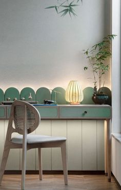 a white chair sitting in front of a counter top next to a potted plant