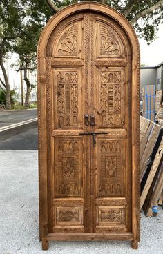 an old wooden door with intricate carvings on the front and side doors are shown in this photo