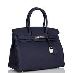 This Birkin is in Bleu Nuit togo leather with palladium hardware and has tonal stitching, front flap, two straps with center toggle closure, clochette with lock and two keys, and double rolled handles. The interior is lined with Bleu Nuit chevre and has one zip pocket with an Hermes engraved zipper pull and an open pocket on the opposite side. Collection: Z Origin: France Condition: Pristine; new or never (plastic on hardware) Accompanied by: Hermes box, Hermes dustbag, clochette, lock, two keys, clochette dustbag, felt, rainhat, carebook, ribbon Measurements: 11.75" width x 9.5" height x 6" depth; 4.25" handle drop