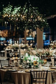 the tables are set with white and green centerpieces for an elegant wedding reception