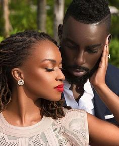 a man and woman kissing each other while they are dressed in formal attire with red lipstick