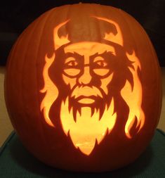 a carved pumpkin with an image of a man's face and beard on it