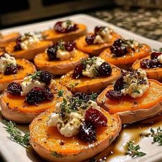 baked sweet potatoes with cranberry sauce and herbs on top are ready to be served