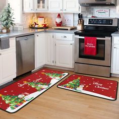 two christmas themed kitchen mats on the floor in front of an oven and dishwasher