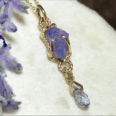 "Please go to my Instagram to watch the video about this pendant ~ A lovely genuine purple-blue color tanzanite glistens in a hollow 14k yellow gold wire bezel.  Set with a light blue color sapphire bead is so fiery, vibrant and intense!  A unique little piece with so much character. All handcrafted by me in my Michigan studio. Gem: approx. 12mm x 7mm / 2.15ct / genuine purple-blue tanzanite / with inclusions and imperfection surface            6mm x 3mm/ genuine light blue bead / with inclusion Unique Tanzanite Jewelry Gift, Unique Tanzanite Jewelry For Gifts, Handmade Tanzanite Yellow Gold Jewelry, Lavender Tanzanite Jewelry For Gifts, Necklace Sapphire, Boulder Opal Ring, 14k Yellow Gold Necklace, Halo Necklace, Yellow Gold Necklace