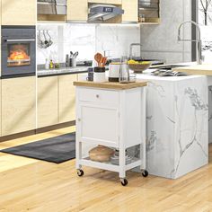 a kitchen with an island and stove in the center, surrounded by wood flooring