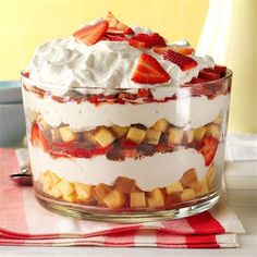 a trifle with strawberries and whipped cream on top