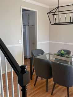 a dining room table with four chairs and a planter on the top of it