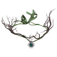 an image of a headpiece made out of branches and green ribbon tied to it