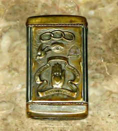 a lighter with an egyptian design on the top and bottom, sitting on a marble surface