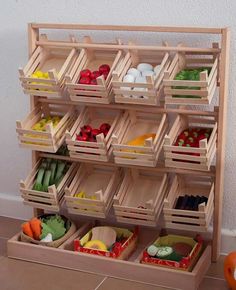 a wooden shelf filled with lots of different types of vegetables and fruit in bins