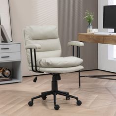 a white office chair sitting on top of a hard wood floor next to a computer desk