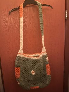 a crocheted purse hanging on a door