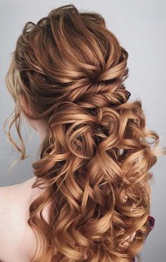 the back of a woman's head with long curly hair and curls in it