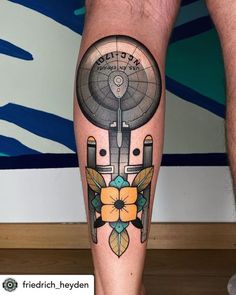 a man's leg with a clock and flowers on it