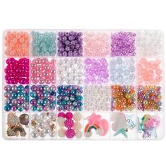 a large assortment of beads and charms in a plastic tray on a white background with clippings