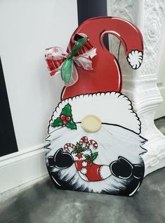 a santa claus mailbox decorated with candy canes