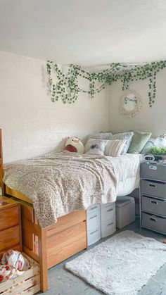 a bedroom with a bed, dressers and drawers