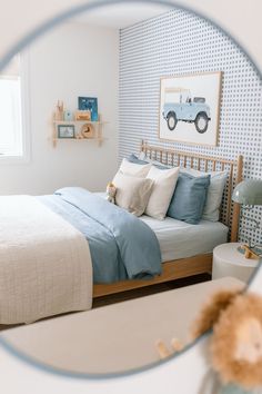 a teddy bear is sitting on the bed in front of a mirror that shows it's reflection