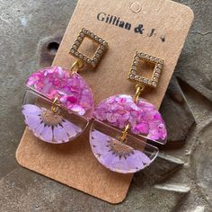 the earrings are made out of glass and pink flowers