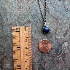 A genuine Lapis Lazuli stone has been wrapped in sterling silver. The pendant hangs from a sterling silver chain. The end of the chain features a lobster claw clasp and a 3-inch extender chain allowing the necklace to be slightly adjustable in length.Be sure to see all photos and video for size and color reference.Lapis Lazuli: About 8mmSelect your desired finish and necklace length when ordering. The necklace photographed is shown at an 18-inch length modeled on a women's size S/M mannequin wit Sterling Silver Wire Wrapped Round Pendant, Sterling Silver Wire Wrapped Round Pendant Jewelry, Minimalist Wire Wrapped Sterling Silver Necklace, Spiritual Hand Wrapped Lapis Lazuli Jewelry, Sterling Silver Wire Wrapped Pendant Crystal Necklaces, Sterling Silver Wire Wrapped Pendant Crystal Necklace, Adjustable Wire Wrapped Sterling Silver Necklace, Adjustable Sterling Silver Wire Wrapped Necklace, Sterling Silver Hand Wrapped Necklace For Gift