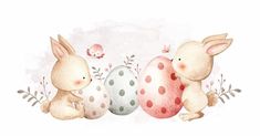 two rabbits sitting next to each other in front of an egg with polka dots on it