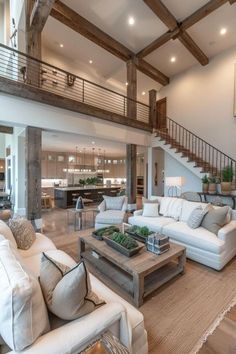 a living room filled with furniture and a staircase