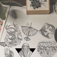 some drawings are sitting on top of a piece of paper next to a rubber stamp