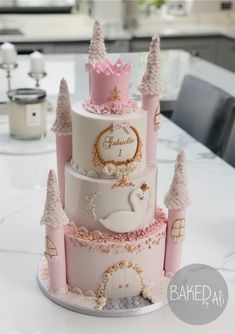 a three tiered cake is decorated with pink and white icing, trees, and a princess's castle