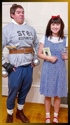 a man and woman dressed in costumes standing next to each other