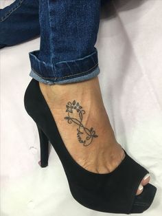 a woman's foot with a tattoo on it