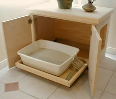 a white dish is sitting on a tray under a cabinet