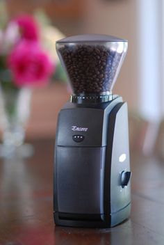 a coffee grinder sitting on top of a wooden table