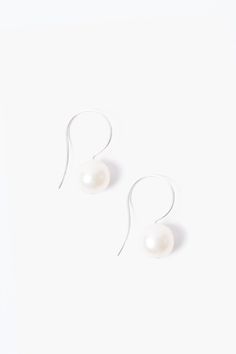 These elegant drop earrings features a white baroque pearl on sterling silver hooks. Pair it with the White Baroque Pearl Pendant Long Necklace to complete the look. Approx. 0.5" in length. Handmade in Vietnam. Classic White Drop Earrings, Classic White Pear-shaped Earrings, Classic Pearl Earrings With French Hook, White Pearl Earrings With French Hook For Formal Occasions, White Pearl Earrings With French Hook For Gift, Formal White Pearl Earrings With French Hook, Classic Pearl Earrings With French Hook As Gift, White Drop Pearl Earrings, Sterling Silver Pearl Earrings With French Hook