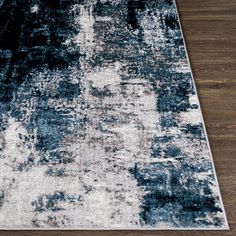 an area rug with dark blue and white colors