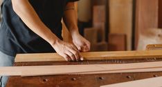 a person cutting wood with a pair of scissors