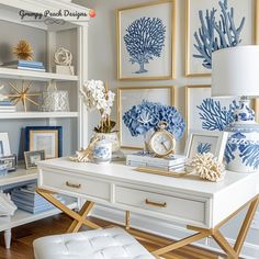 a white desk topped with blue and white vases next to pictures on the wall