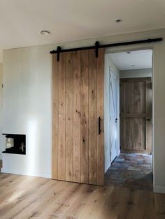 an empty living room with wood floors and sliding doors