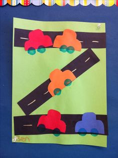 this is an art project for kids to do with construction paper and construction vehicles on the road