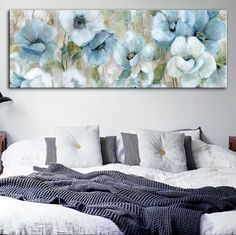 a large painting on the wall above a bed