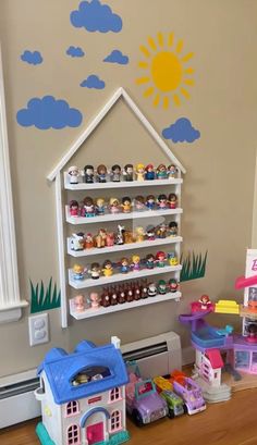 there are many toys on the table in this playroom, including a doll house