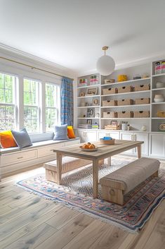 a living room filled with furniture and bookshelves in front of a large window