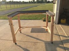 a workbench sitting on top of a cement floor in front of a garage