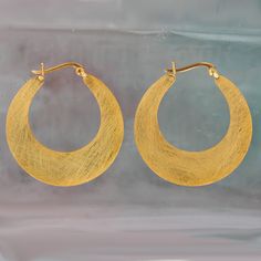 These lovely large flat hoops will add some glamour and style to any daytime look. Individual and versatile the gold vermiel crescent hoop is finished in a luxurious brushed gold. Gold  Plated Sterling Silver Size: 35 mm All of our sterling silver jewellery comes beautifully packaged in our branded gift box with the option of a handwritten gift note available. We try to process all orders within 24 hours. Our standard delivery method is Royal Mail 48 which normally take 2-3 days. International d Gold Crescent Hoop Earrings For Everyday, Modern Gold Crescent Hoop Earrings, Everyday Gold Crescent Hoop Earrings, Modern Crescent Yellow Gold Hoop Earrings, Gold Plated Crescent Hoop Earrings, Gold-plated Crescent Hoop Earrings, Gold Crescent Hoop Earrings With Ear Wire, Yellow Gold Crescent Hoop Earrings, Creole Earrings