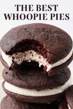 chocolate cookies with white frosting are stacked on top of each other