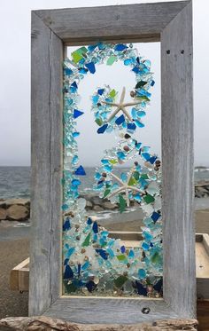 an old window with sea glass and starfish on it