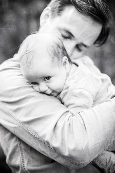 a man holding a baby in his arms